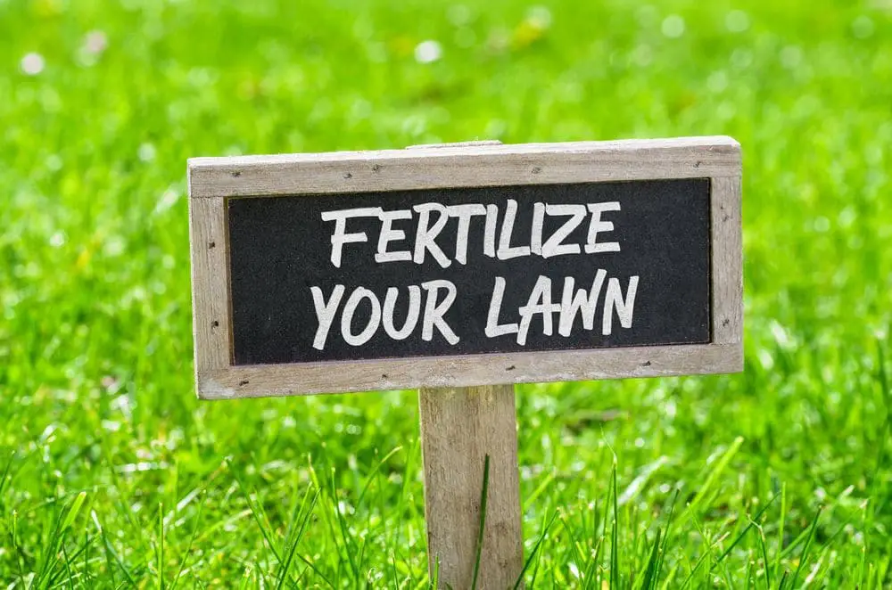 Sign on a green lawn - Fertilize your lawn