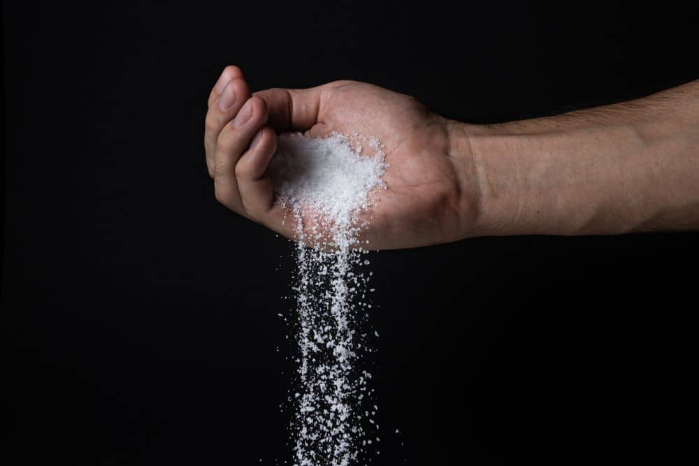 Salt pours from hand - Putting Salt on Grass (What you Need to Know!) - Patricia Godwin